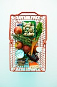 Fresh and packaged groceries in a shopping basket