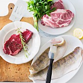 Beef steak, pork collar steaks and fresh fish fillets for a barbecue