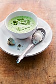 Cream of herb soup with poached quail's eggs
