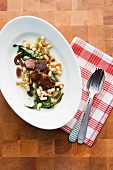 Braised beef cheeks with white beans and radicchio