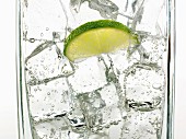 Mineral water with ice cubes and a slice of lime