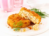 Two Salmon and Dill Fish Cakes on a Plate; Fork
