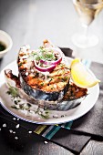 Grilled salmon steaks with red onions, salt and dill