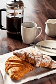 Chocolate and cinnamon croissants and a cup of black coffee