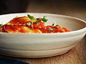 Raviolis with Tomato Sauce in Black Plate