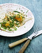 Fried eggs with chives