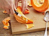 Pumpkin wedges being peeled