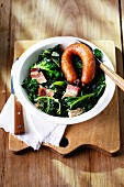 Green kale with Pinkel (smoked sausage from bacon, groats and spices) on a plate