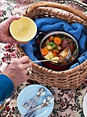 A soup pot in a picnic basket
