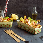 Fruity avocado salad in two paper dishes