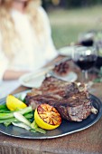 Pork steak with spring onions and lemons