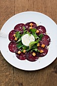 Beetroot carpaccio with goat's cheese, croutons and fresh herbs