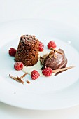 Chocolate dessert with raspberry in a pool of cream