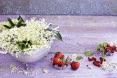 A summer arrangement featuring elderflowers and fresh berries