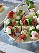 Ham and mozzarella skewers with basil