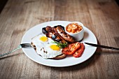 A English breakfast with sausages, fried eggs and beans