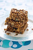 A stack of three muesli bars on a plate