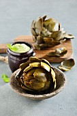 Cooked artichokes with a dip