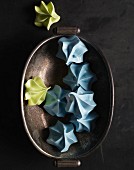 Blue and green meringues in metal dish