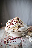 Meringue with cream, lychees, pomegranate and slivered almonds