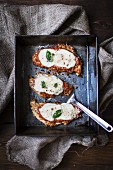 Breaded chicken breast topped with tomato sauce and mozzarella