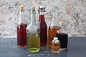 An arrangement of various different types of vinegar in bottles