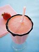 Strawberry milkshake in a glass with a chocolate rim
