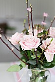 Bouquet of pastel roses with flowering branches