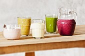 Various smoothies on a wooden table