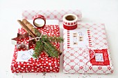 Wrapped Christmas presents (washi tape, block prints, cinnamon sticks, cord, pastry cutter)