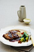 Veal escalope with masala sauce and a courgette medley