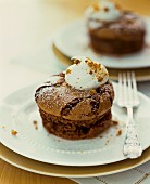 A chocolate soufflé with a dollop of cream