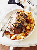 Roast beef with a mustard glaze and roast potatoes