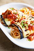 Grilled aubergine rolls with tomato sauce and spaghetti
