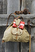 Traditional knapsack with Christmas arrangement next to old ski pole