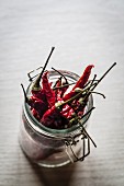 Dried red chilli peppers in a jar
