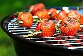 Strawberries with rosemary on a barbecue