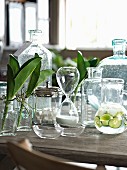 Arrangement of various glass vessels on wooden table in elegant country-house style