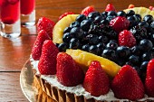 A fruit tart with strawberries and blueberries