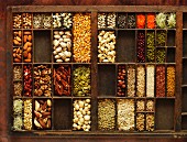 A seedling tray filled with various nuts, legumes and seeds