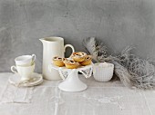 An arrangement of coffee crockery with mince pies on a cake stand