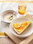 A slice of cream cheese cheesecake with oranges