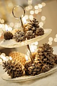 Pine cones and candles on cake stand