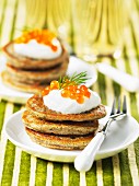 Buckwheat blinis with sour cream and salmon caviar