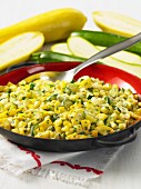 A courgette medley with sweetcorn in a pan