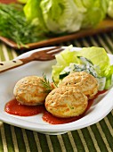 Vegetables cakes with courgette and dill on tomato sauce