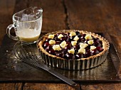 Black cherry tart with frangipane in a tart in on a baking tray