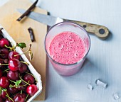 A smoothie made with cherries, bananas, soya milk and vanilla