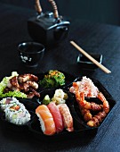Japanese food on a black plate
