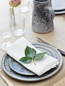 Festive place setting with rose leaves